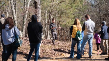 teacher showing class twigs to identify tree