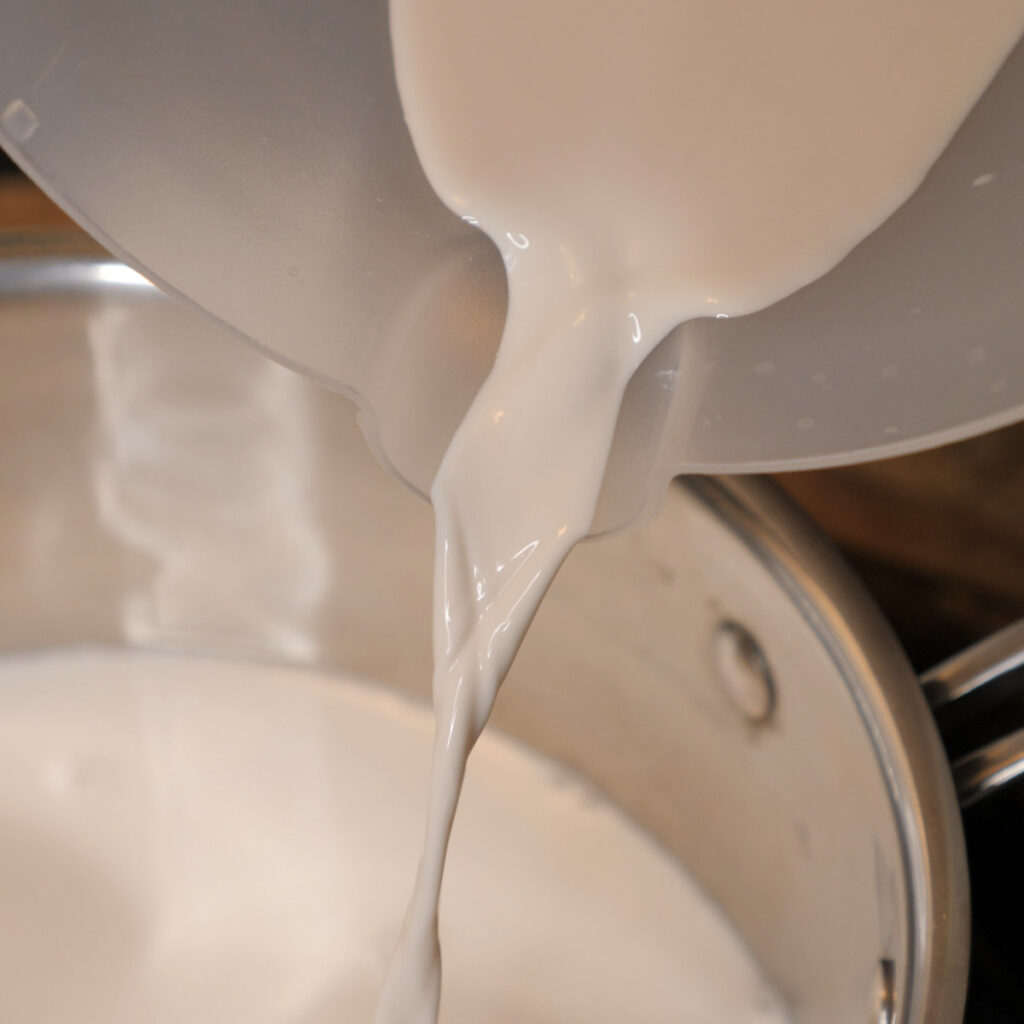 Pouring Black Walnut Milk To Heat